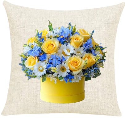 Yellow roses and blue flowers arranged in a round yellow container.