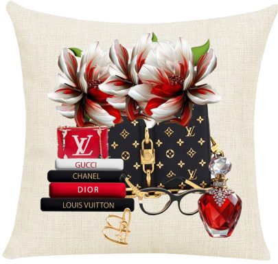 Decorative pillow with luxury bags, books, flowers, and a perfume bottle.